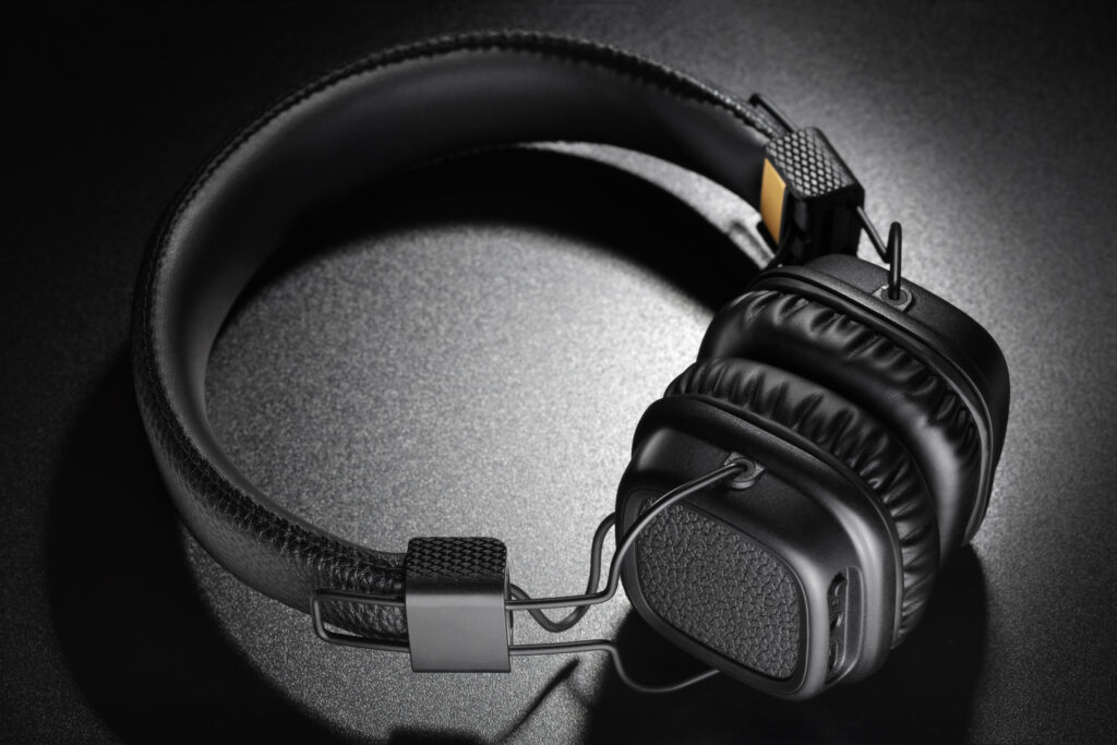 Headphones. Wireless black on-ear earphones on dark slate background